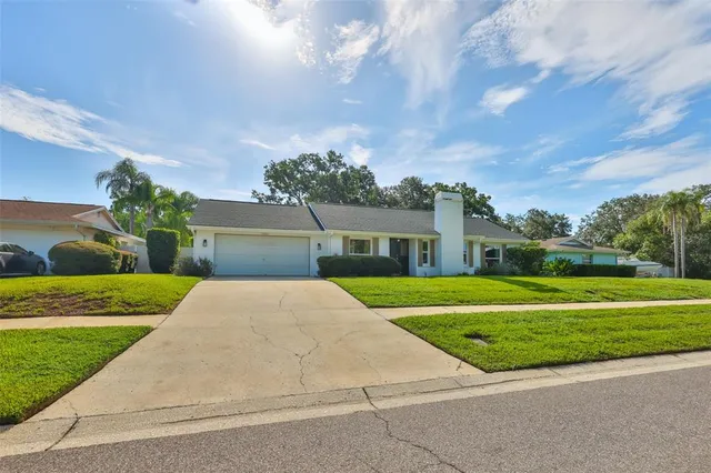 a front view of house with yard and green space