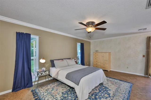 a view of a house with a swimming pool and sitting area