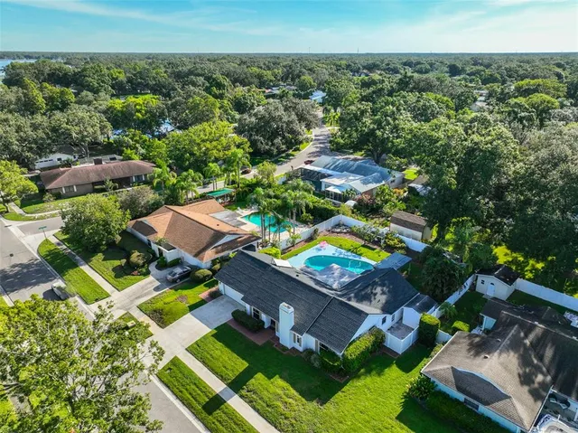 an aerial view of residential houses with yard