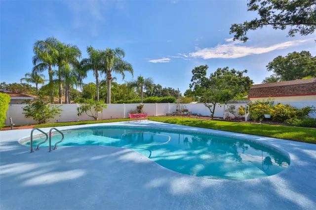 a view of a swimming pool with an outdoor space and seating area