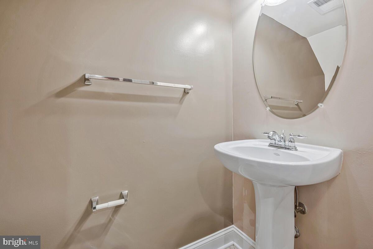 12354 Rollys Ridge Avenue, Unit 2201 Upper Marlboro, MD 20774 - Photo 11 of 20 a bathroom with a sink a mirror and a toilet