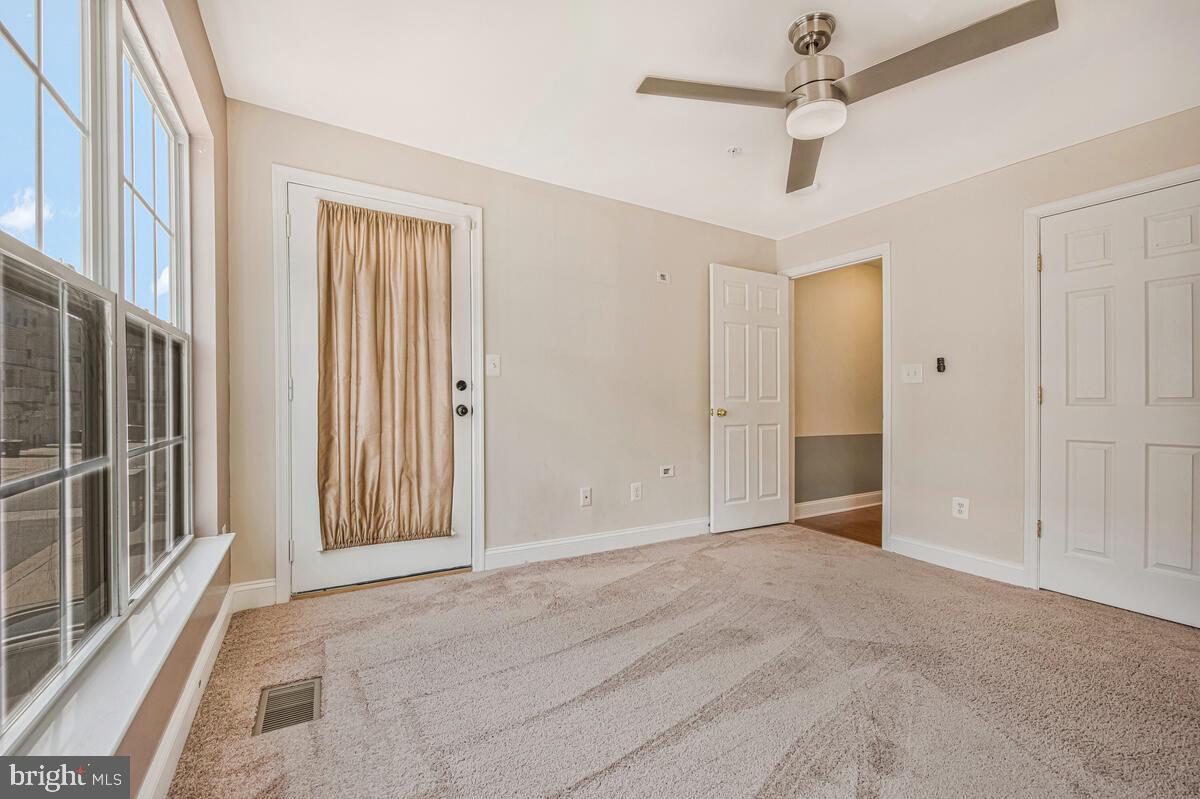12354 Rollys Ridge Avenue, Unit 2201 Upper Marlboro, MD 20774 - Photo 14 of 20 a view of an empty room with a window
