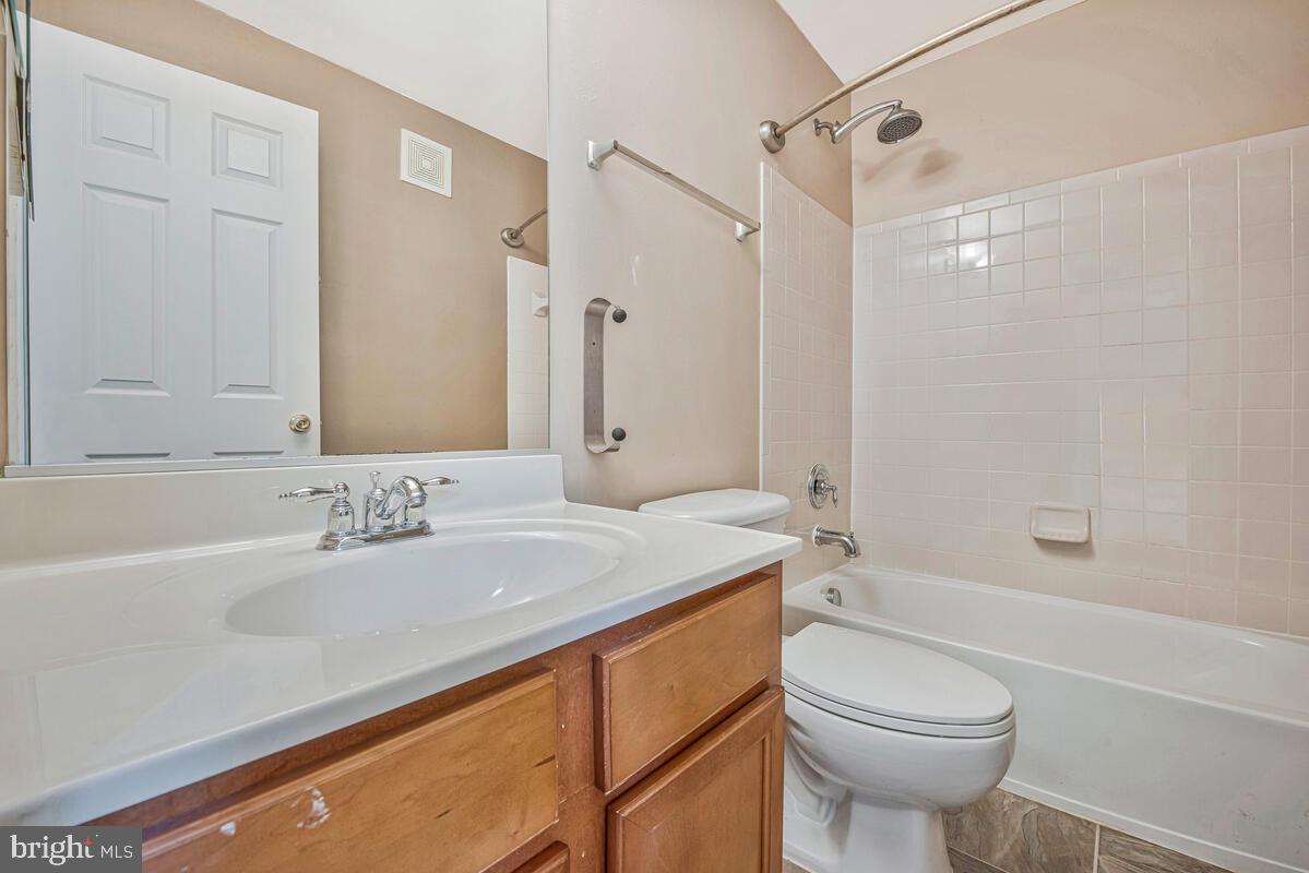 12354 Rollys Ridge Avenue, Unit 2201 Upper Marlboro, MD 20774 - Photo 15 of 20 a bathroom with a sink a toilet and shower