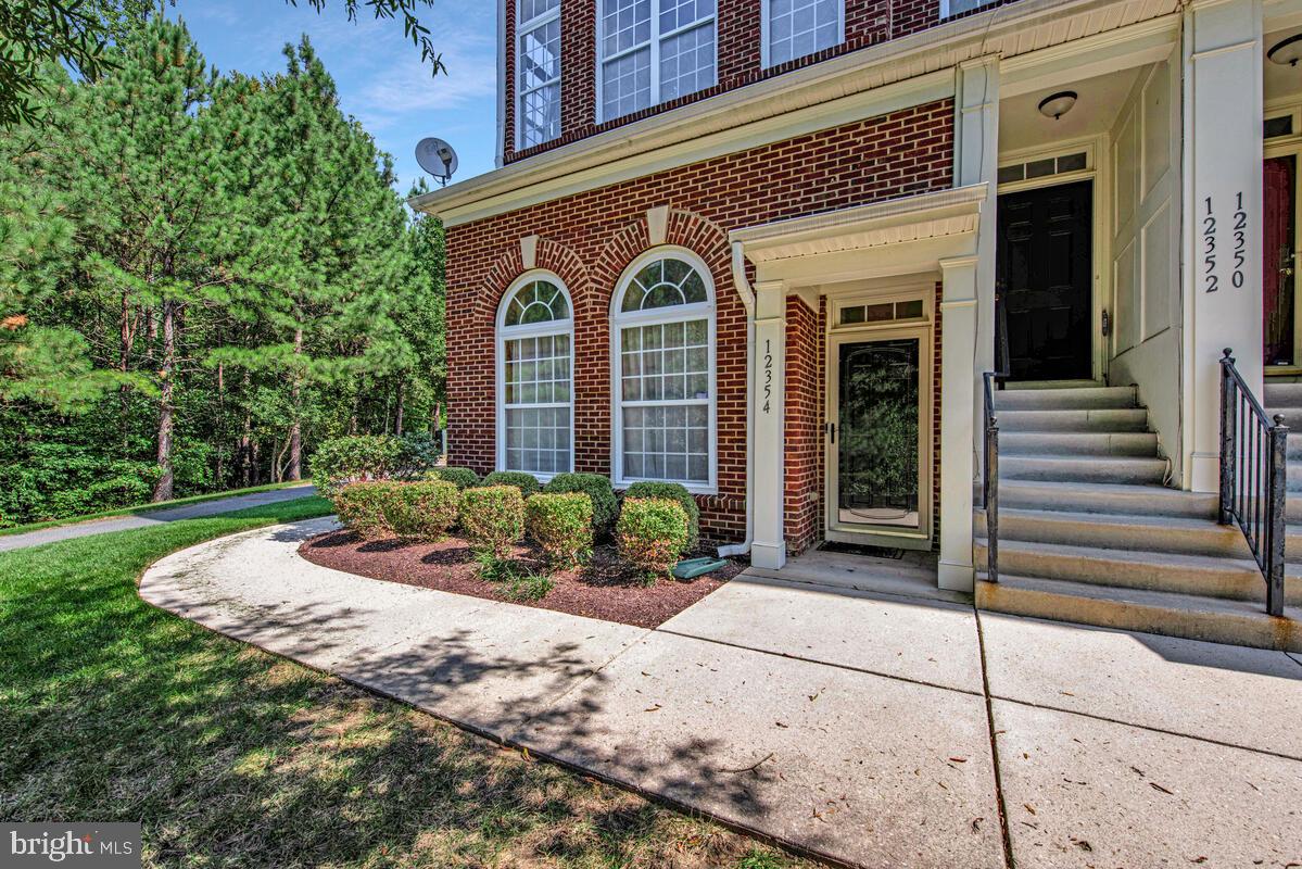 12354 Rollys Ridge Avenue, Unit 2201 Upper Marlboro, MD 20774 - Photo 2 of 20 a front view of a house with garden