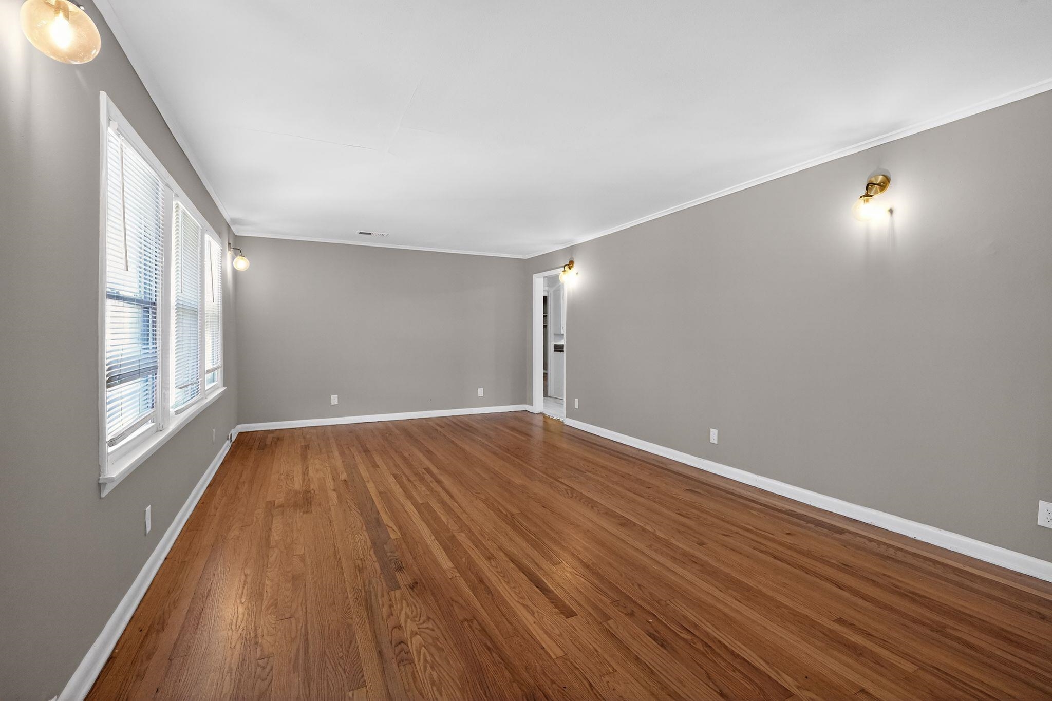 4094 Auburn Road Memphis, TN 38116 - Photo 3 of 30 Spare room with dark wood-type flooring and ornamental molding