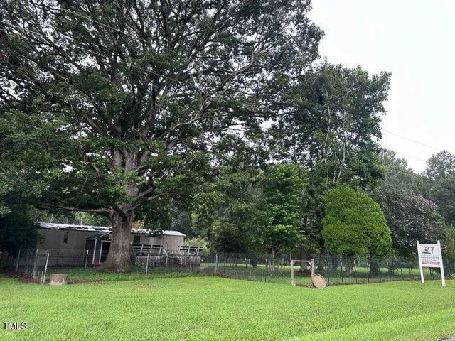 a front view of a building with trees