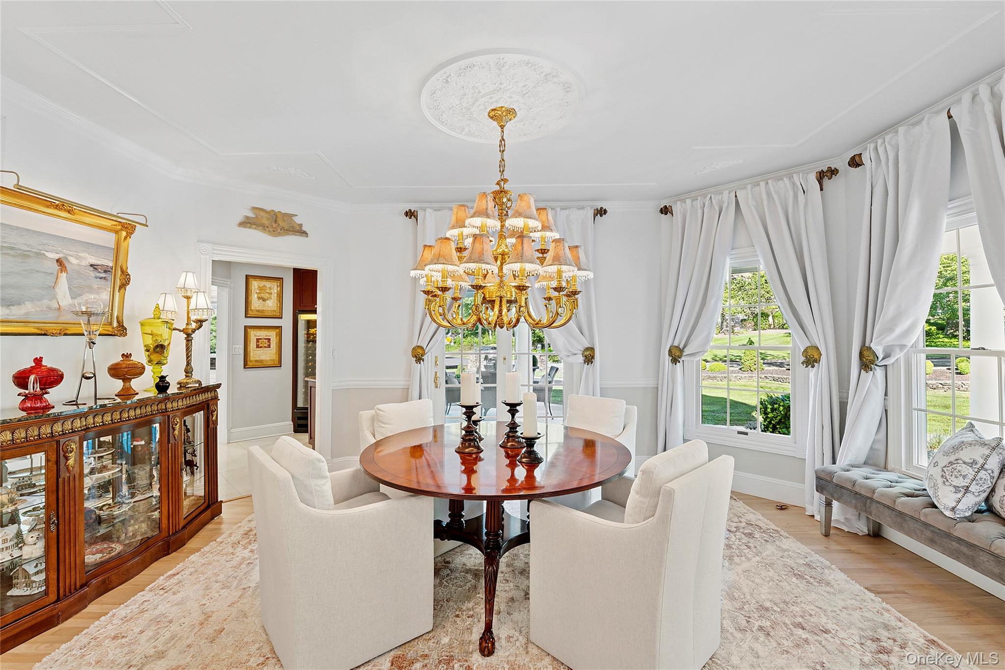 2 North Harbor Down Miller Place, NY 11764 - Photo 16 of 49 a dining room with furniture a chandelier and wooden floor