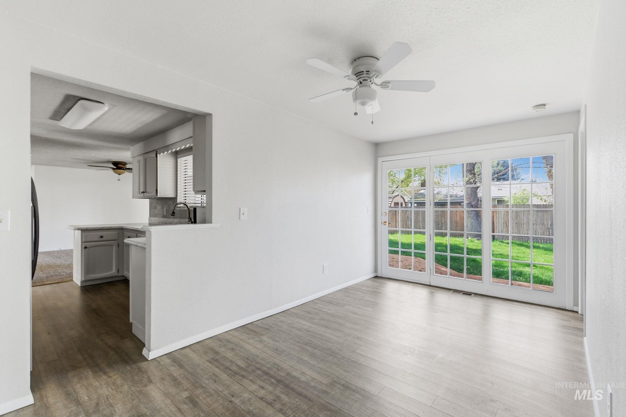 3911 South Constitution Way Boise, ID 83706 - Photo 18 of 40 Unfurnished room with ceiling fan and dark wood-type flooring