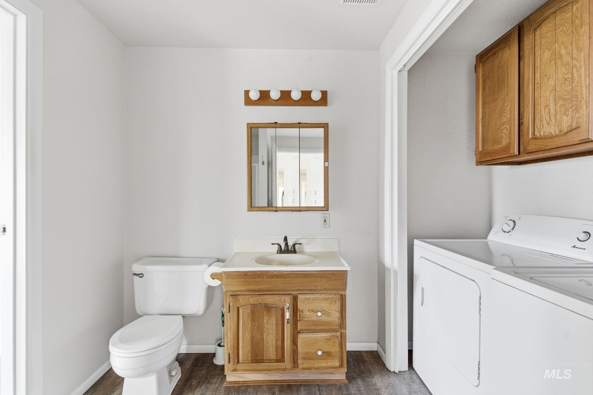 3911 South Constitution Way Boise, ID 83706 - Photo 20 of 40 Bathroom featuring vanity and dark wood-style floors