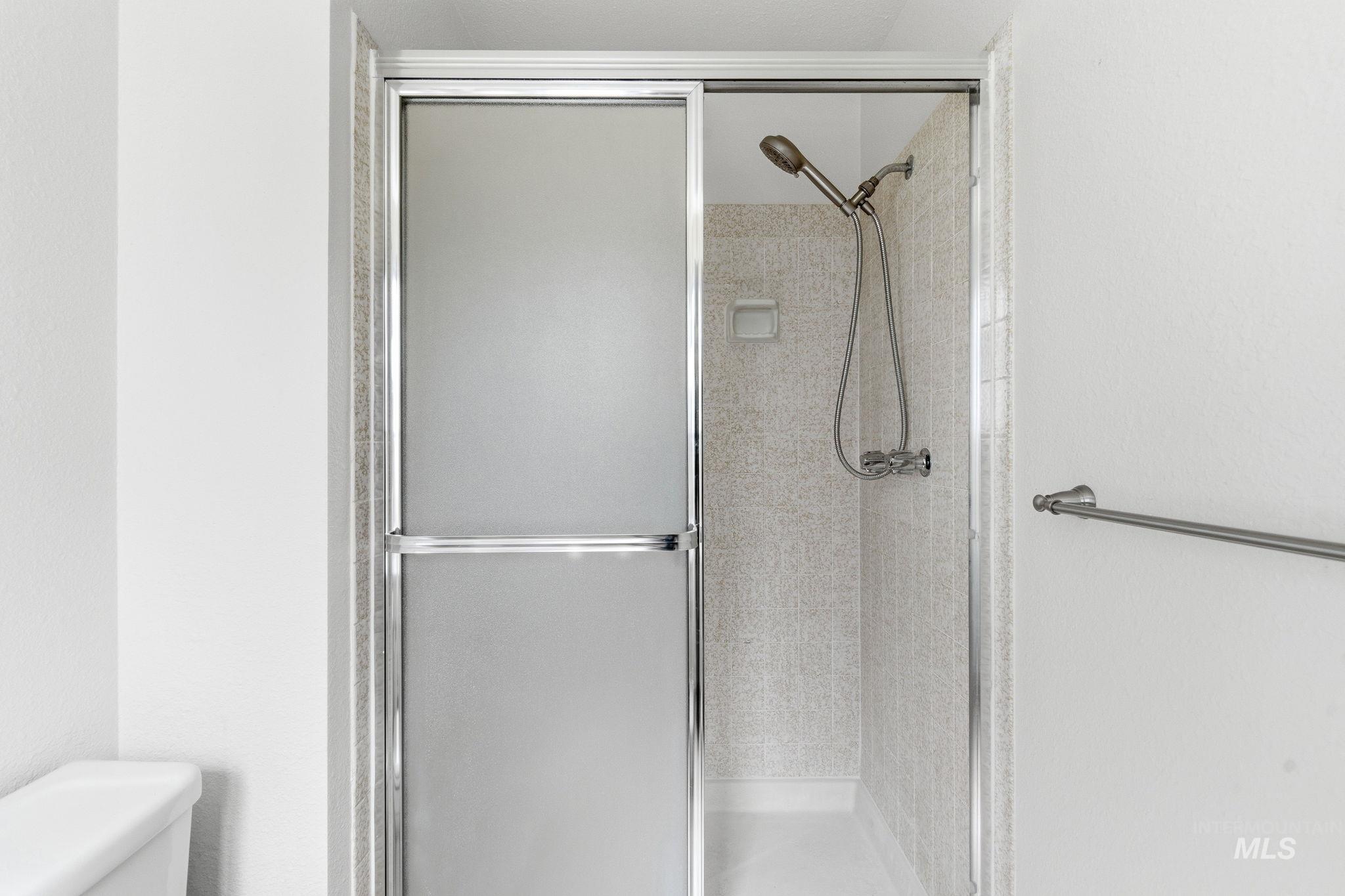 3911 South Constitution Way Boise, ID 83706 - Photo 30 of 40 Full bathroom with a stall shower and toilet