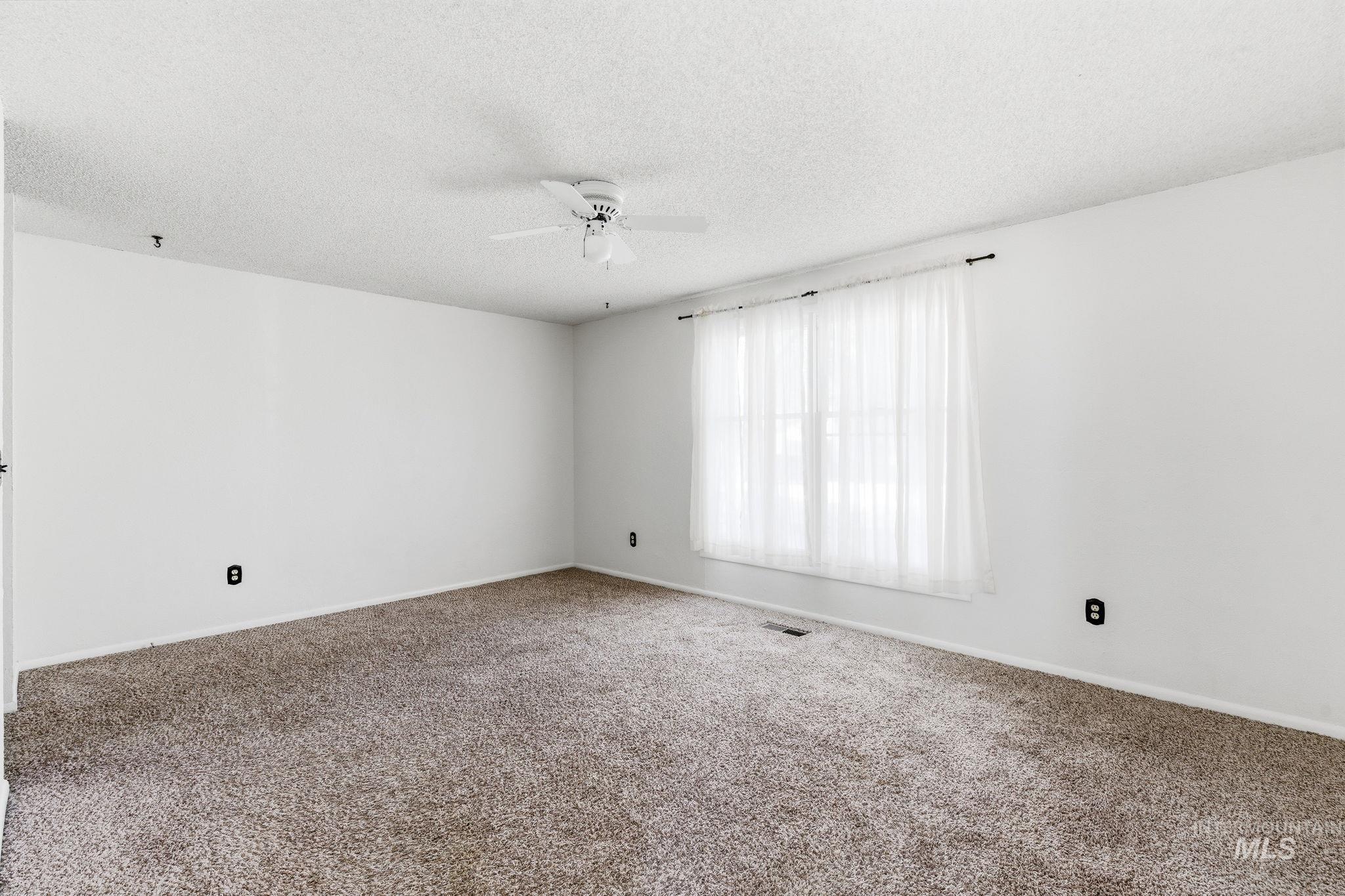 3911 South Constitution Way Boise, ID 83706 - Photo 31 of 40 Empty room featuring carpet floors, a textured ceiling, and ceiling fan