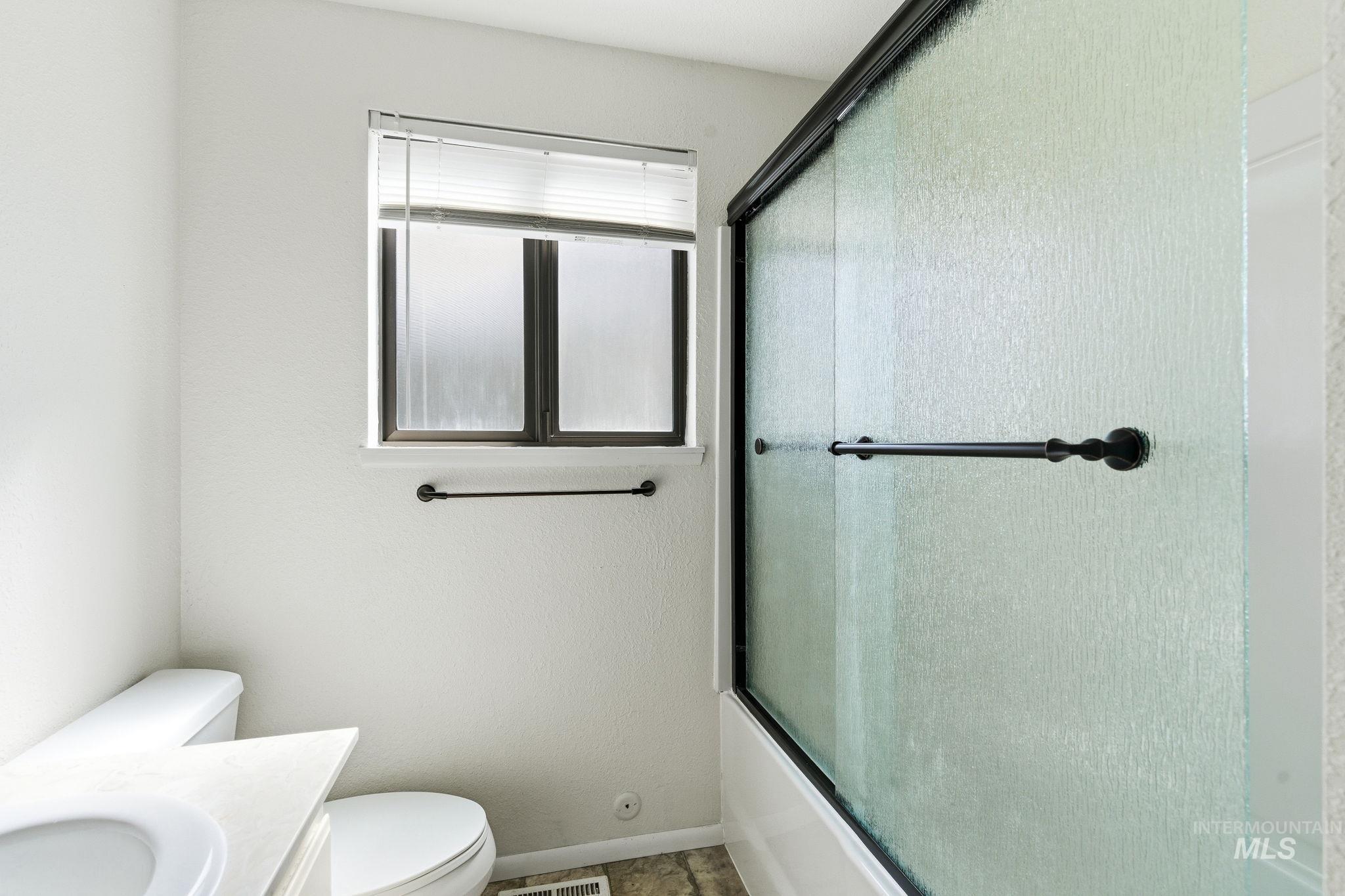 3911 South Constitution Way Boise, ID 83706 - Photo 35 of 40 Bathroom featuring vanity and bath / shower combo with glass door