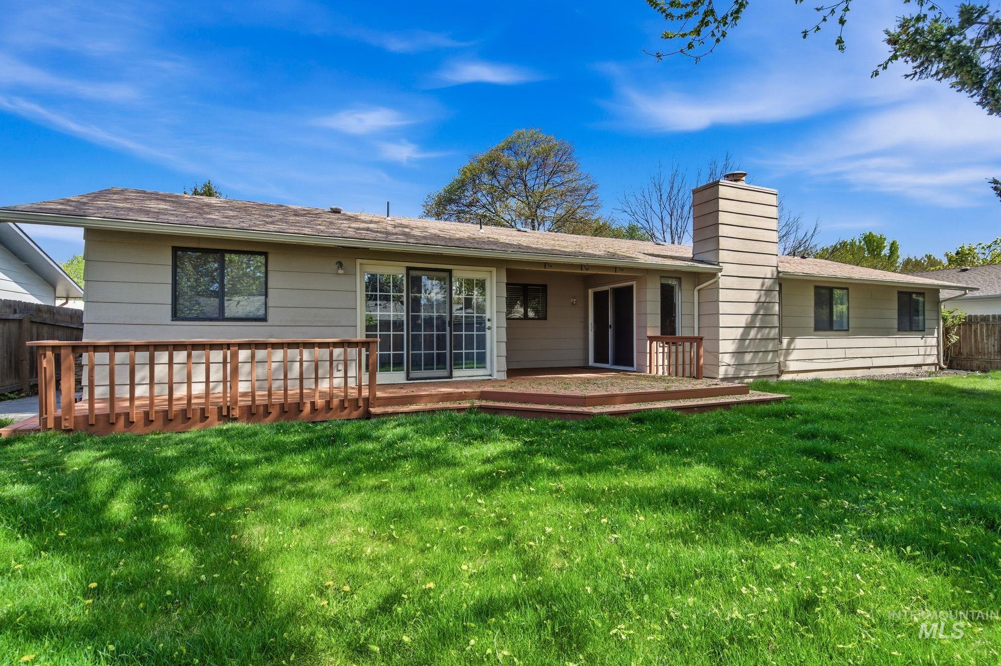 3911 South Constitution Way Boise, ID 83706 - Photo 36 of 40 Back of property featuring a wooden deck and a chimney