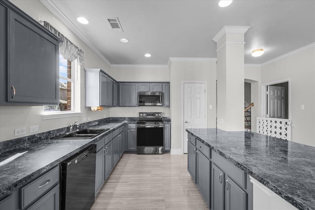 3625 Black Ranch Court Fort Worth, TX 76262 - Photo 11 of 30 a kitchen with stainless steel appliances granite countertop a sink a stove and a refrigerator