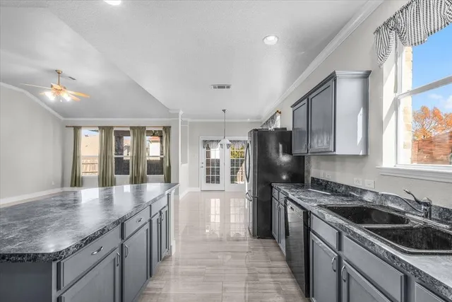 a kitchen with stainless steel appliances granite countertop a sink stove and refrigerator