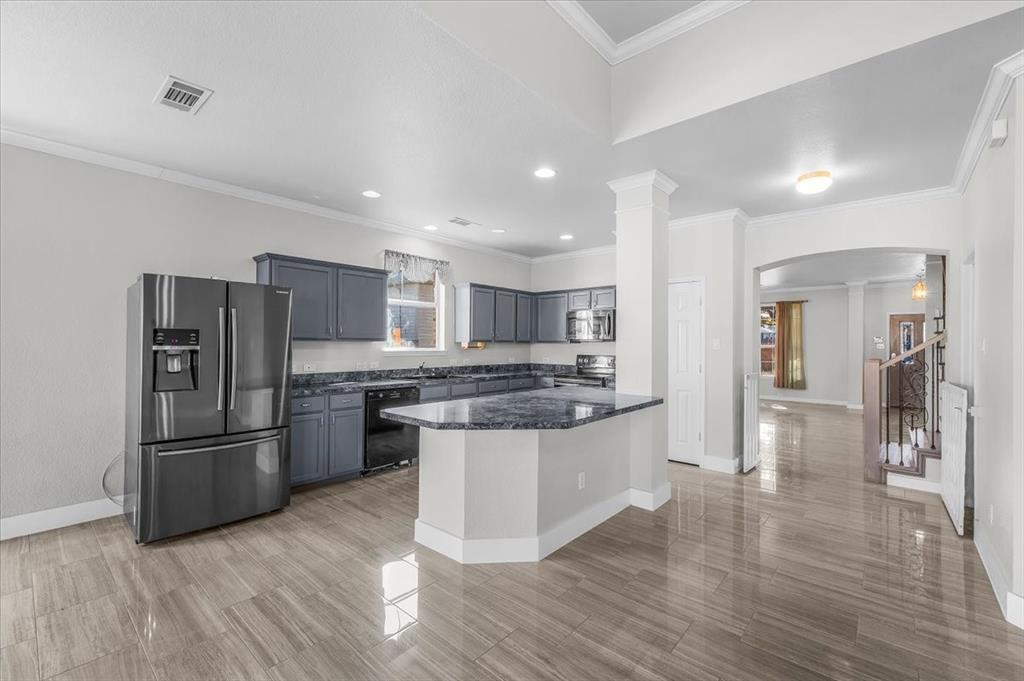 3625 Black Ranch Court Fort Worth, TX 76262 - Photo 13 of 30 a kitchen with stainless steel appliances granite countertop a refrigerator and a stove top oven