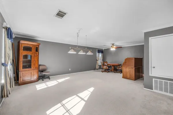 a view of a livingroom with furniture and a window