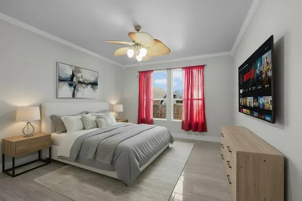 a bedroom with a large bed and a flat screen tv