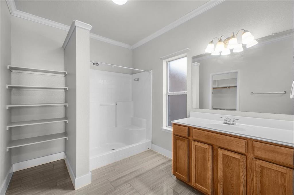 3625 Black Ranch Court Fort Worth, TX 76262 - Photo 24 of 30 a bathroom with a sink double vanity and a mirror