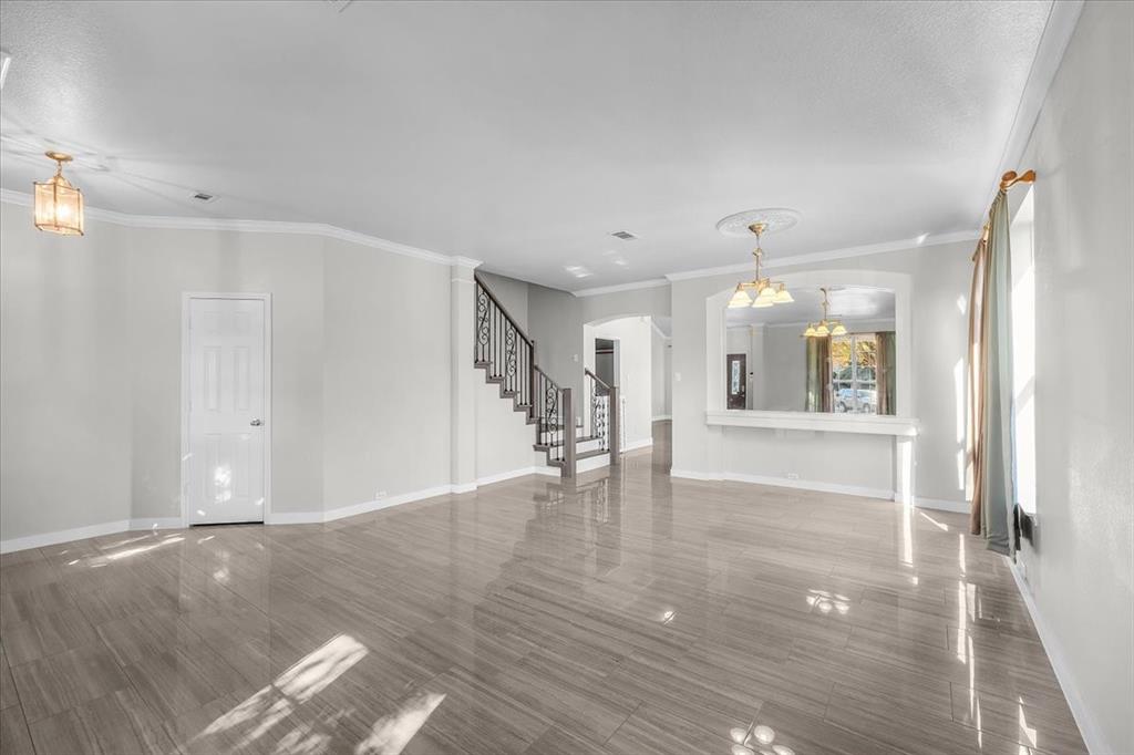3625 Black Ranch Court Fort Worth, TX 76262 - Photo 7 of 30 a view of an empty room with wooden floor and a window