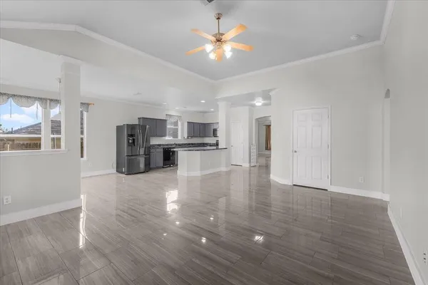 a view of kitchen with refrigerator stove microwave and cabinets