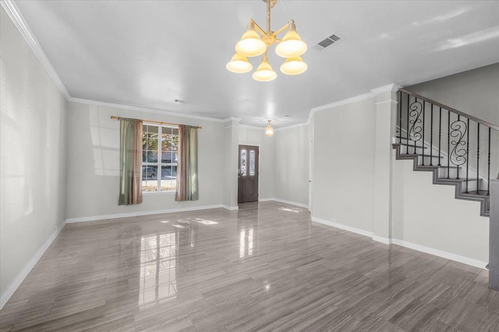 3625 Black Ranch Court Fort Worth, TX 76262 - Photo 10 of 30 a view of an empty room with wooden floor and windows