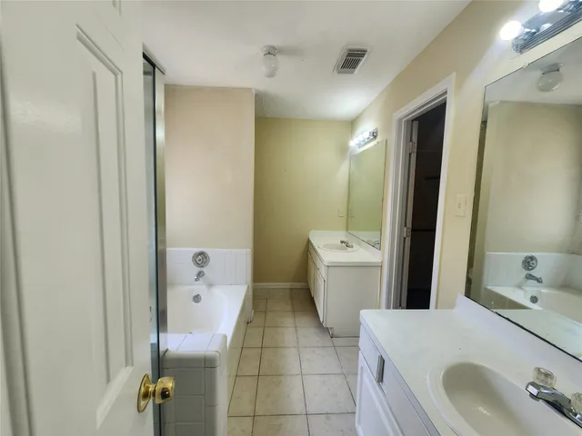a bathroom with a bathtub and shower