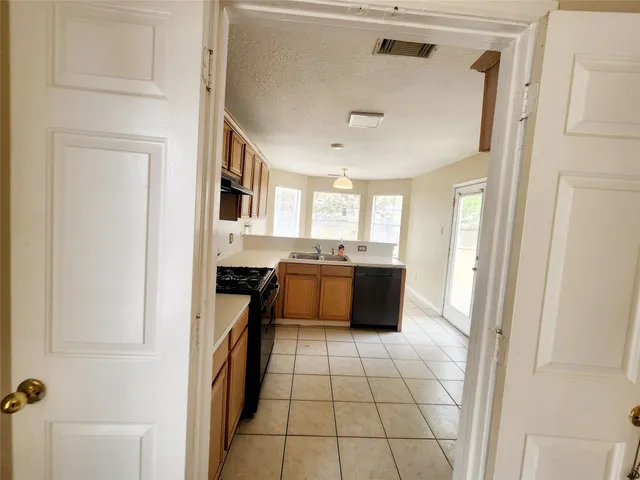 a kitchen with a stove a sink and a microwave