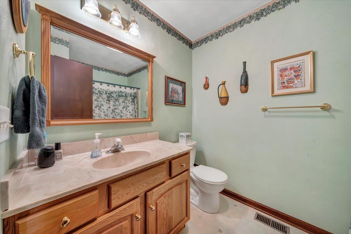 4081 Daugherty Road Salem, VA 24153 - Photo 17 of 34 a bathroom with a toilet sink and mirror