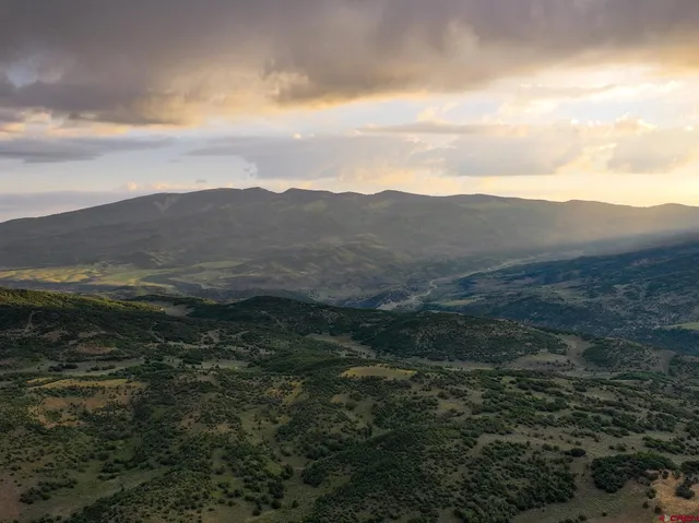 a view of a town with mountains in the background