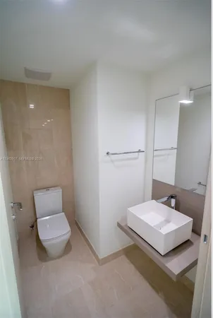 a bathroom with a sink a toilet and mirror