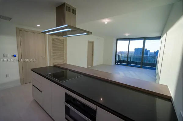 a kitchen with a sink and large window
