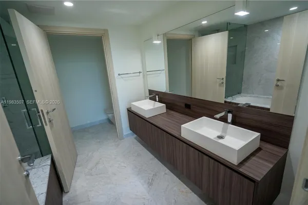 a bathroom with a sink a mirror and a toilet