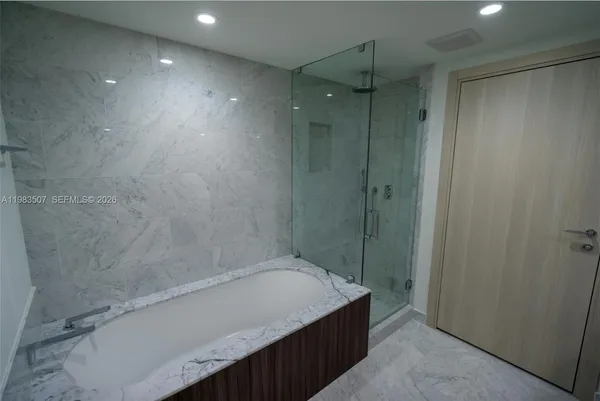 a bathroom with a shower and a tub