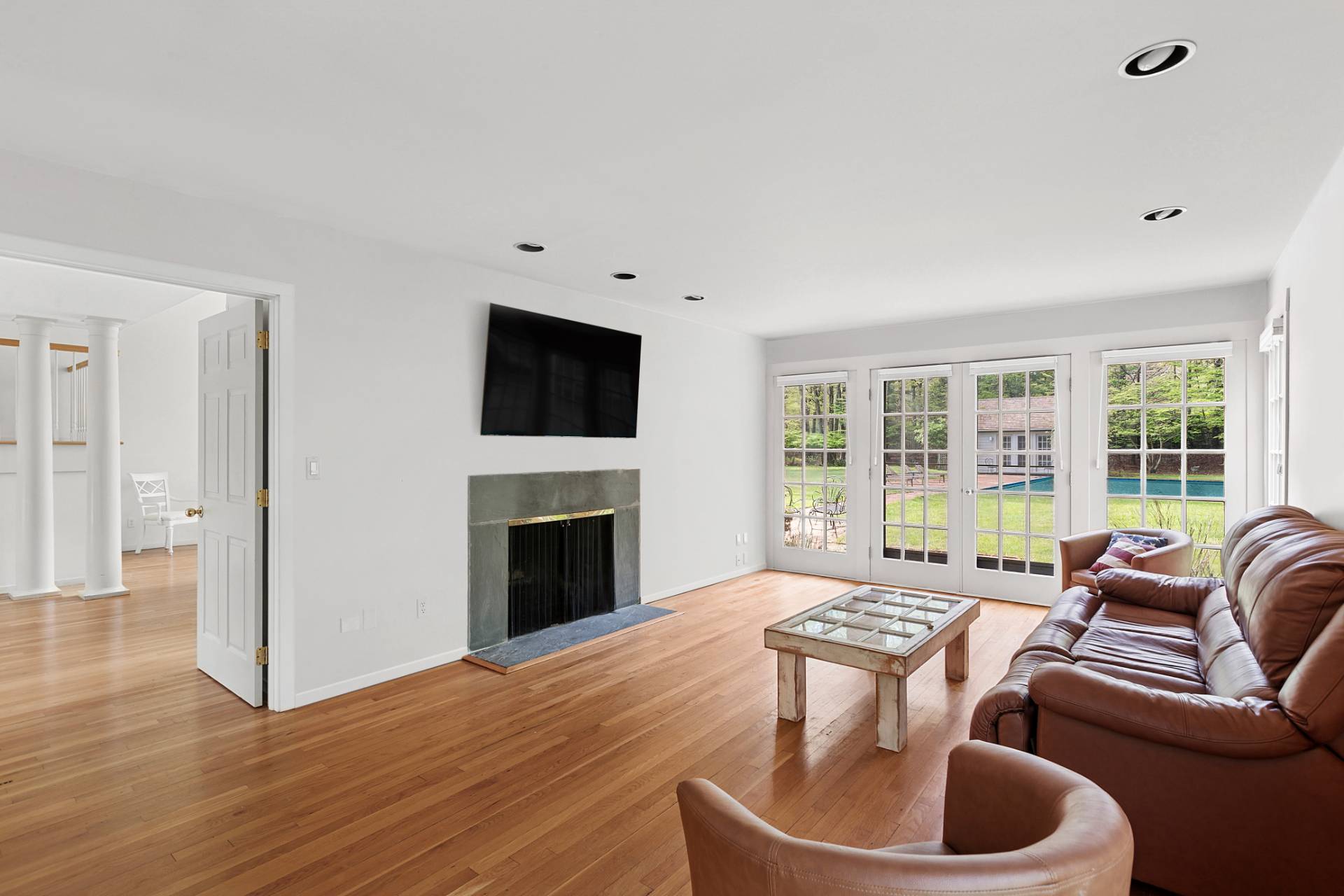 144 Hands Creek Road East Hampton, NY 11937 - Photo 11 of 32 a living room with furniture a fireplace and a flat screen tv