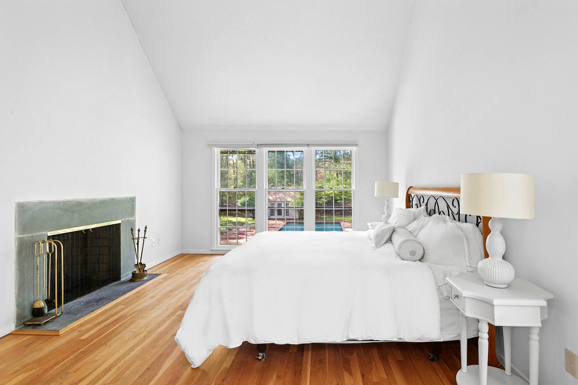 144 Hands Creek Road East Hampton, NY 11937 - Photo 18 of 32 a bedroom with a bed and a fireplace