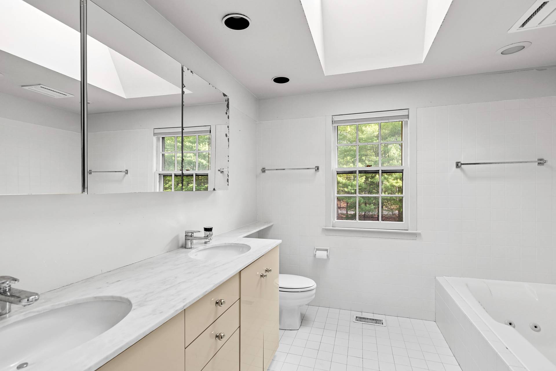 144 Hands Creek Road East Hampton, NY 11937 - Photo 19 of 32 a bathroom with a granite countertop sink mirror vanity bathtub and a toilet