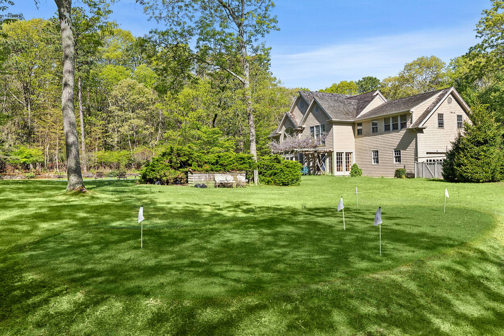 144 Hands Creek Road East Hampton, NY 11937 - Photo 28 of 32 a front view of a house with a yard and trees