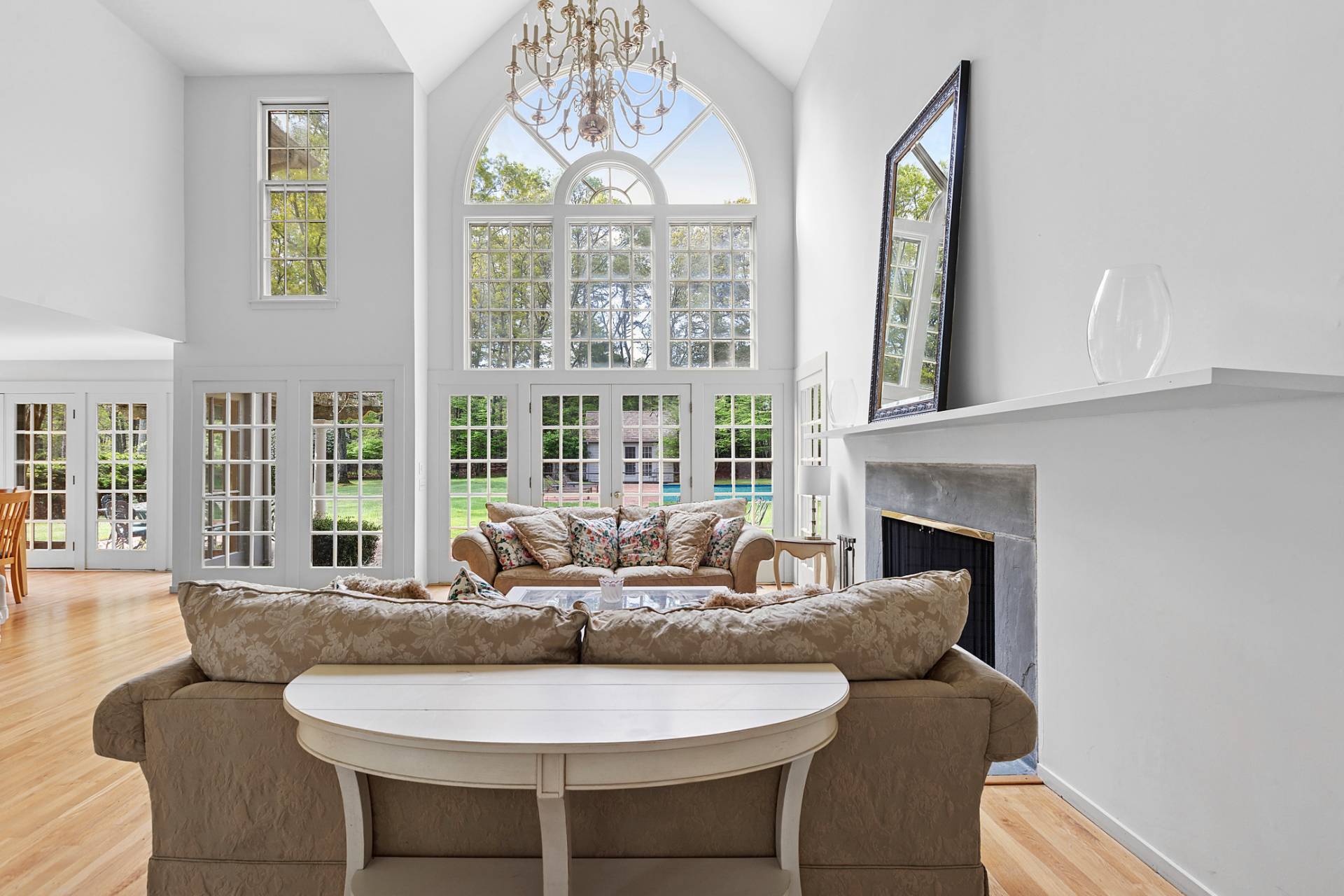 144 Hands Creek Road East Hampton, NY 11937 - Photo 6 of 32 a living room with furniture a chandelier and a large window