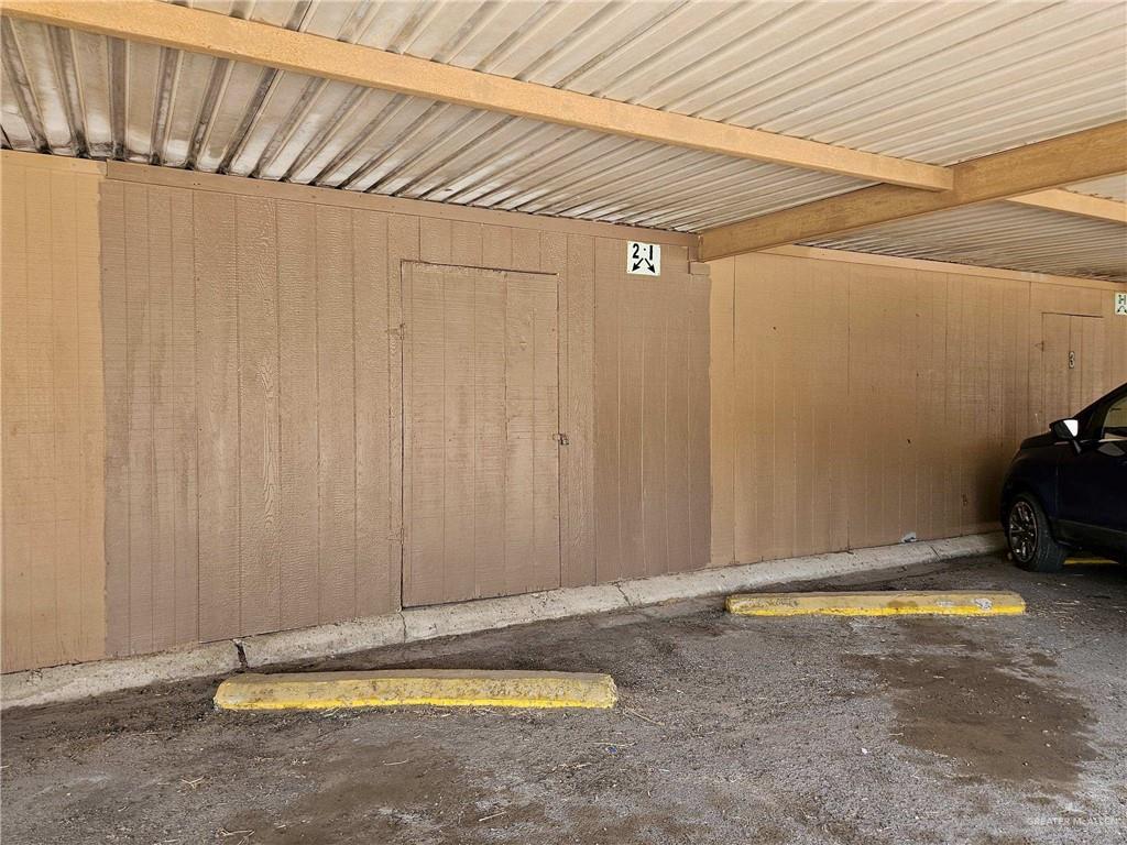 2201 South Jackson Road, Unit 2I Pharr, TX 78577 - Photo 23 of 23 Carport parking space featuring a corrugated metal roof and exposed wooden beams