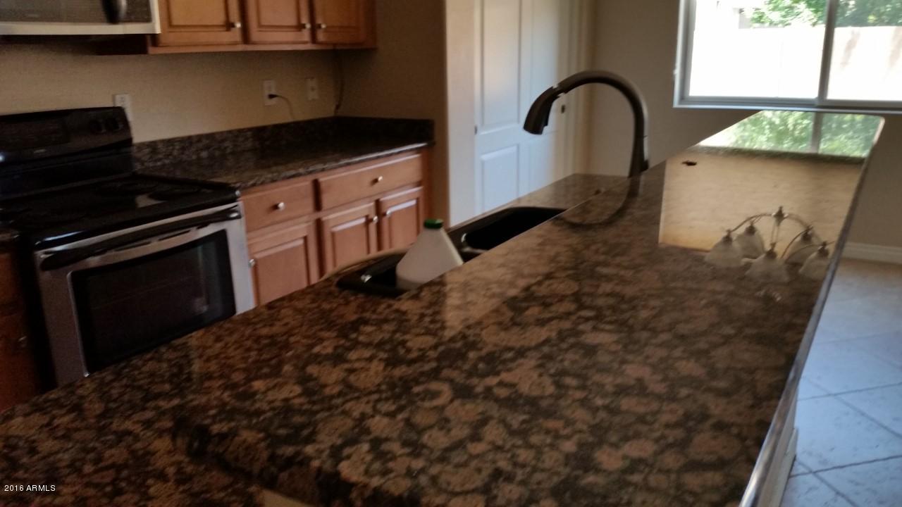 4926 West Apollo Road Laveen, AZ 85339 - Photo 9 of 23 Kitchen island with granite counter