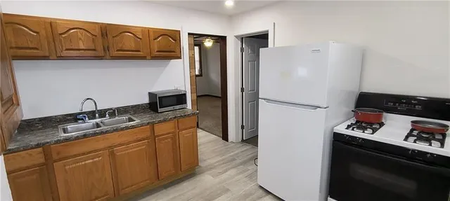 a kitchen with stainless steel appliances granite countertop a refrigerator and a sink