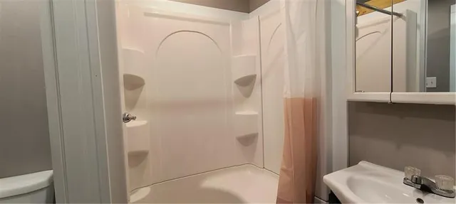 a bathroom with a shower curtain