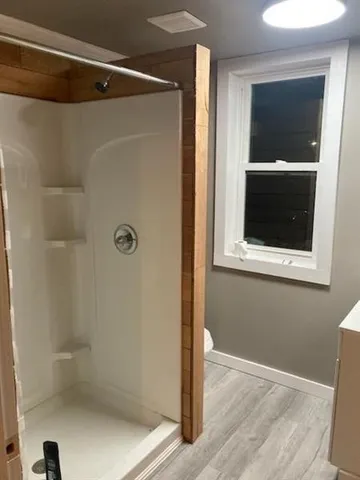 a bathroom with a glass shower door