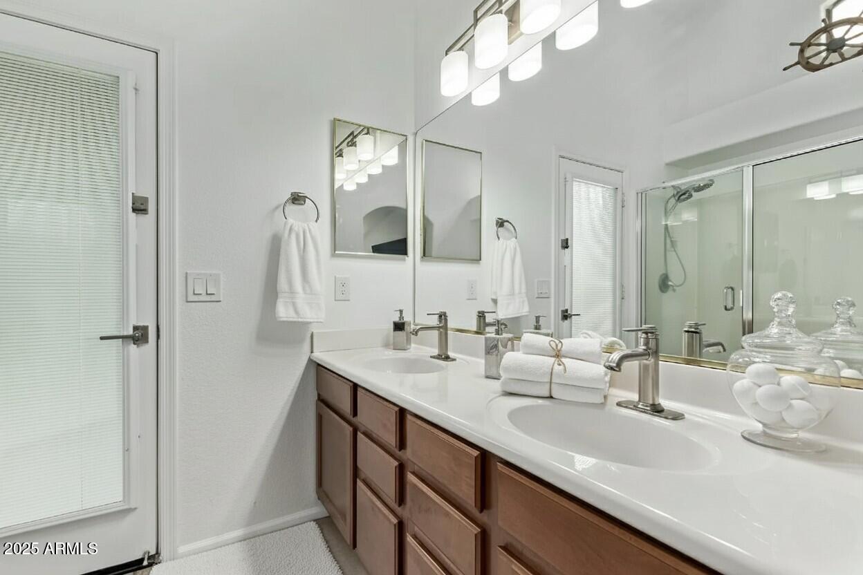 21765 Backus Drive Maricopa, AZ 85138 - Photo 11 of 43 a bathroom with double vanity sinks and a mirror