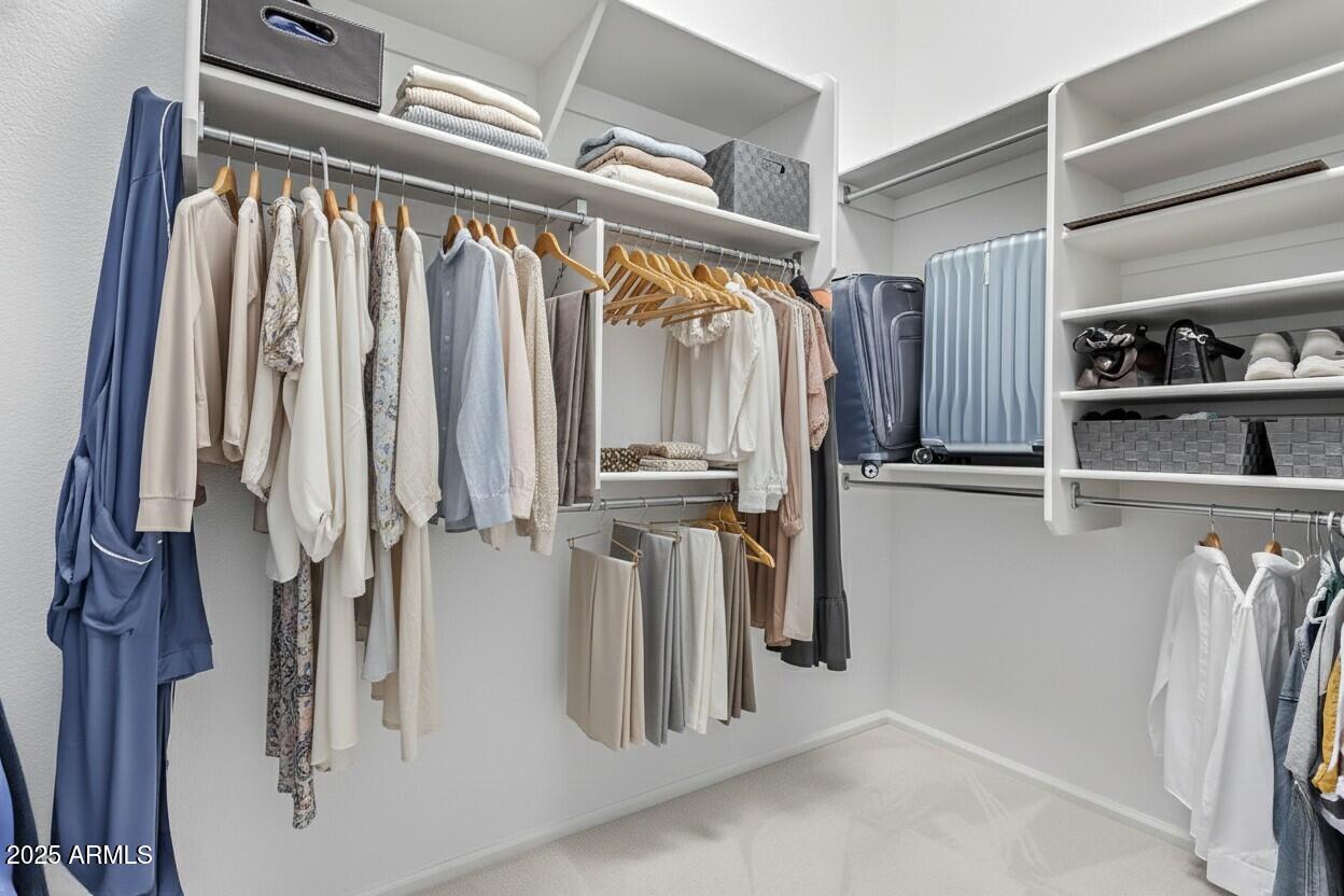 21765 Backus Drive Maricopa, AZ 85138 - Photo 13 of 43 a view of walk in closet with clothes and shoes