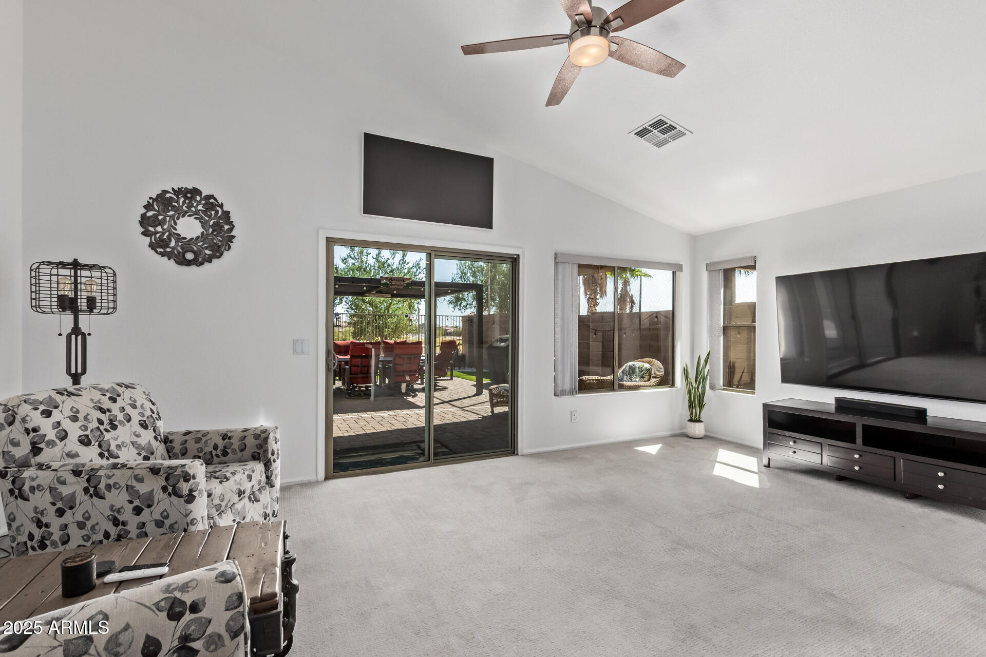21765 Backus Drive Maricopa, AZ 85138 - Photo 16 of 43 a living room with furniture and a flat screen tv