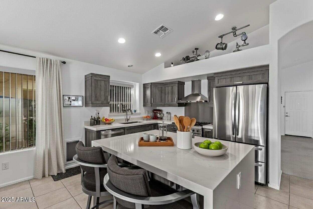21765 Backus Drive Maricopa, AZ 85138 - Photo 20 of 43 a kitchen with stainless steel appliances a dining table and chairs