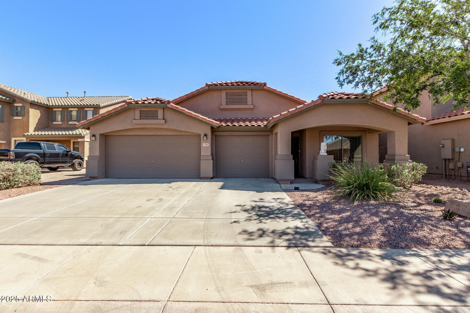 21765 Backus Drive Maricopa, AZ 85138 - Photo 2 of 43 a front view of a house with a garden