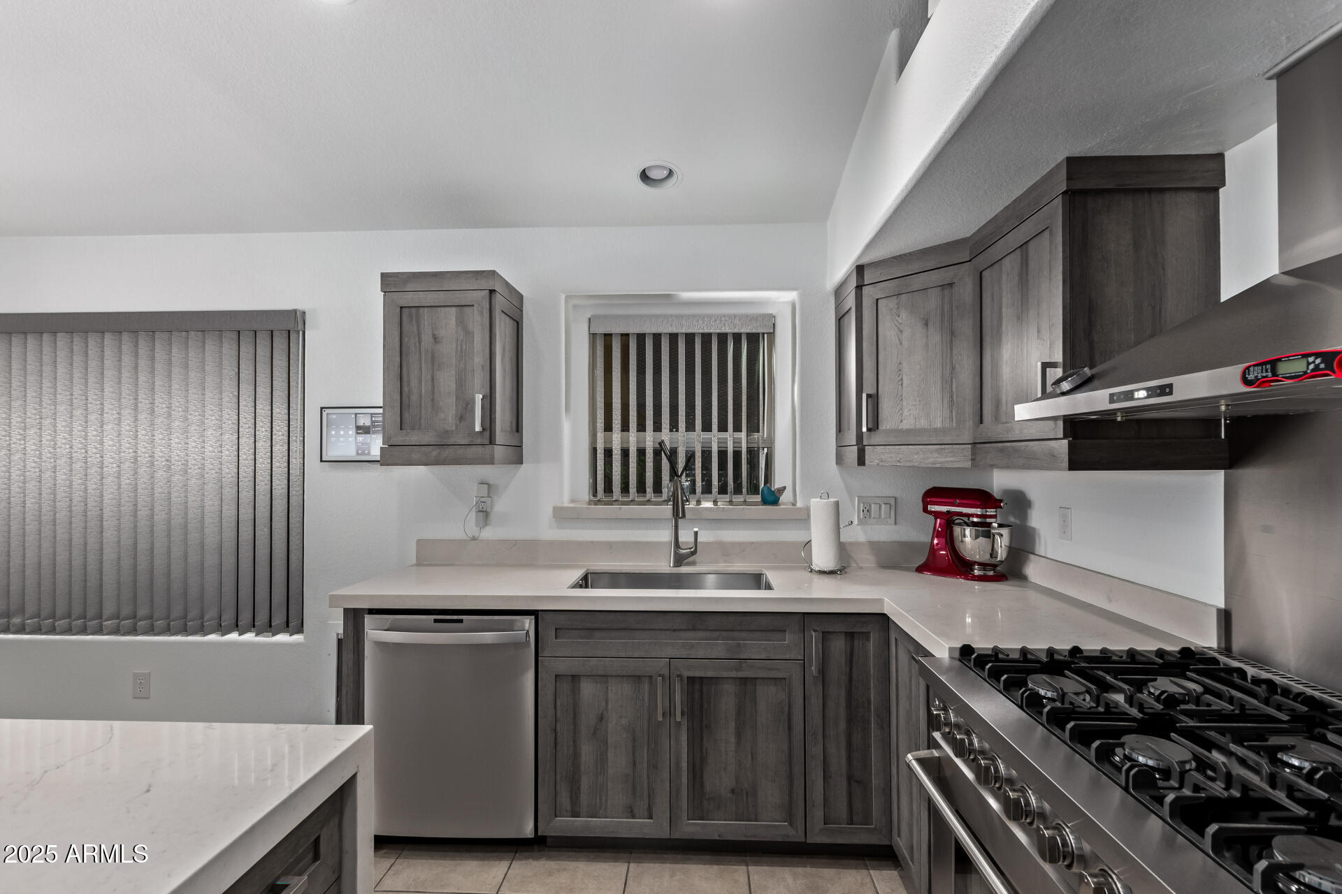 21765 Backus Drive Maricopa, AZ 85138 - Photo 22 of 43 a kitchen with granite countertop a sink stove and cabinets